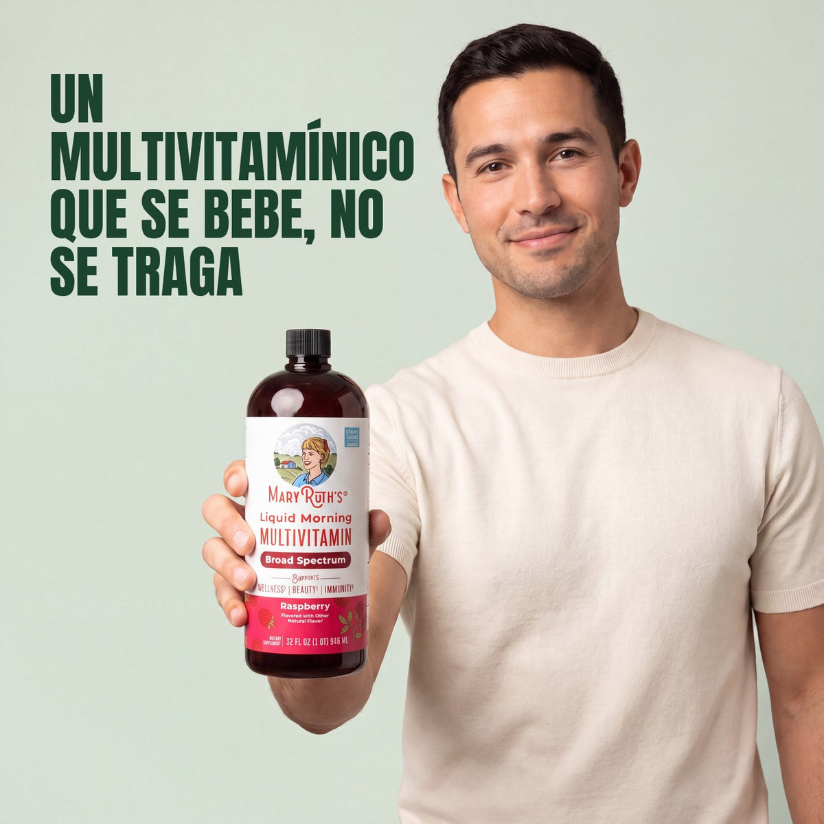 Man holding a MaryRuth Organics Liquid Morning Multivitamin raspberry bottle against a green background