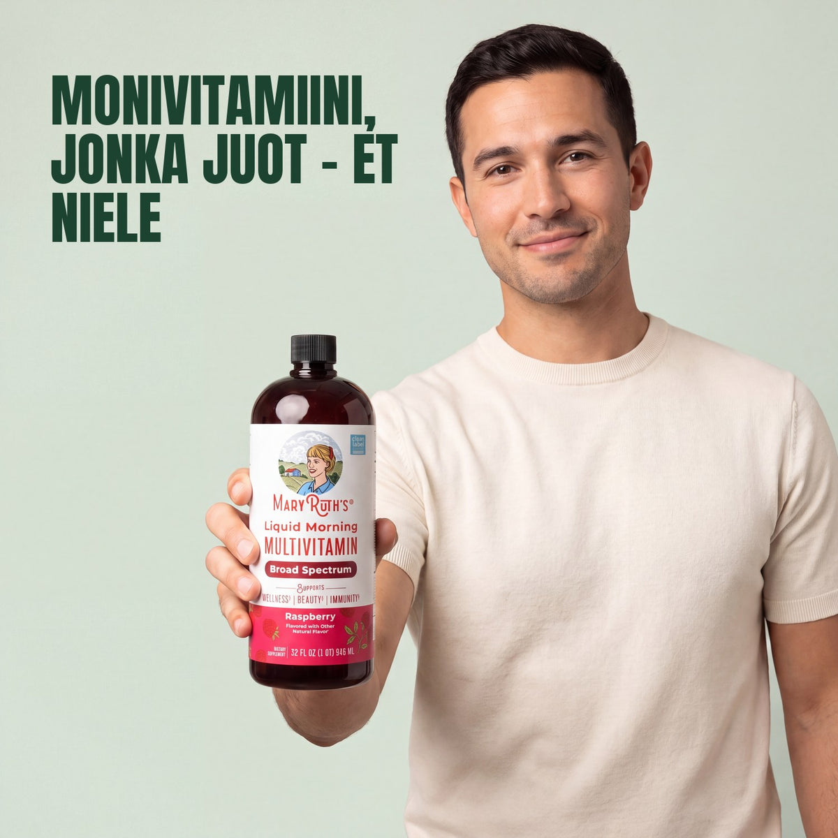 Man holding a MaryRuth Organics Liquid Morning Multivitamin raspberry bottle against a green background