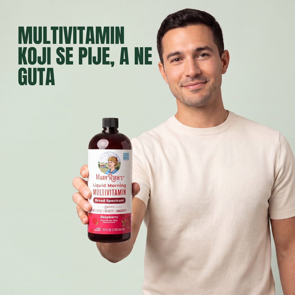 Man holding a MaryRuth Organics Liquid Morning Multivitamin raspberry bottle against a green background