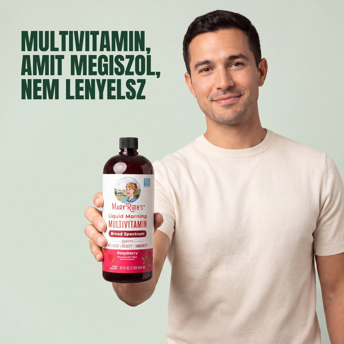 Man holding a MaryRuth Organics Liquid Morning Multivitamin raspberry bottle against a green background
