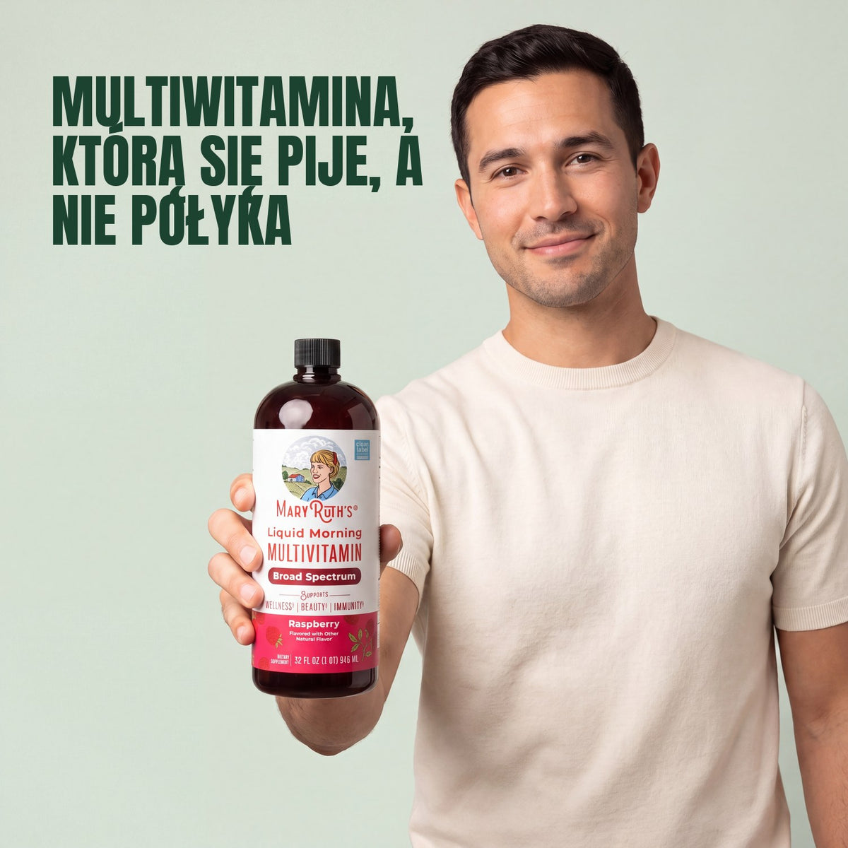 Man holding a MaryRuth Organics Liquid Morning Multivitamin raspberry bottle against a green background