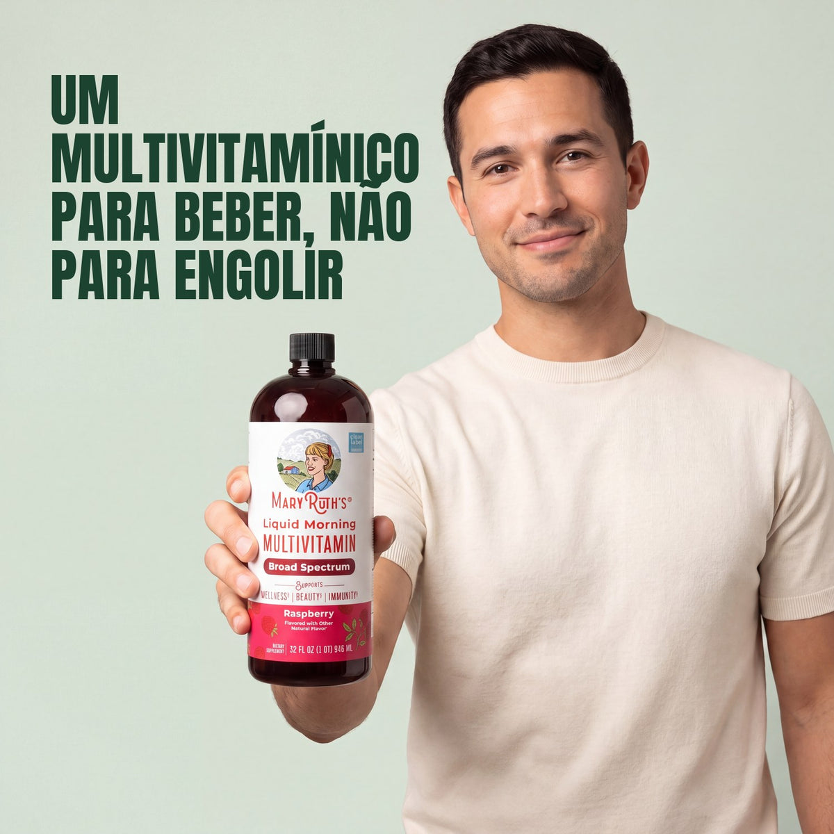 Man holding a MaryRuth Organics Liquid Morning Multivitamin raspberry bottle against a green background