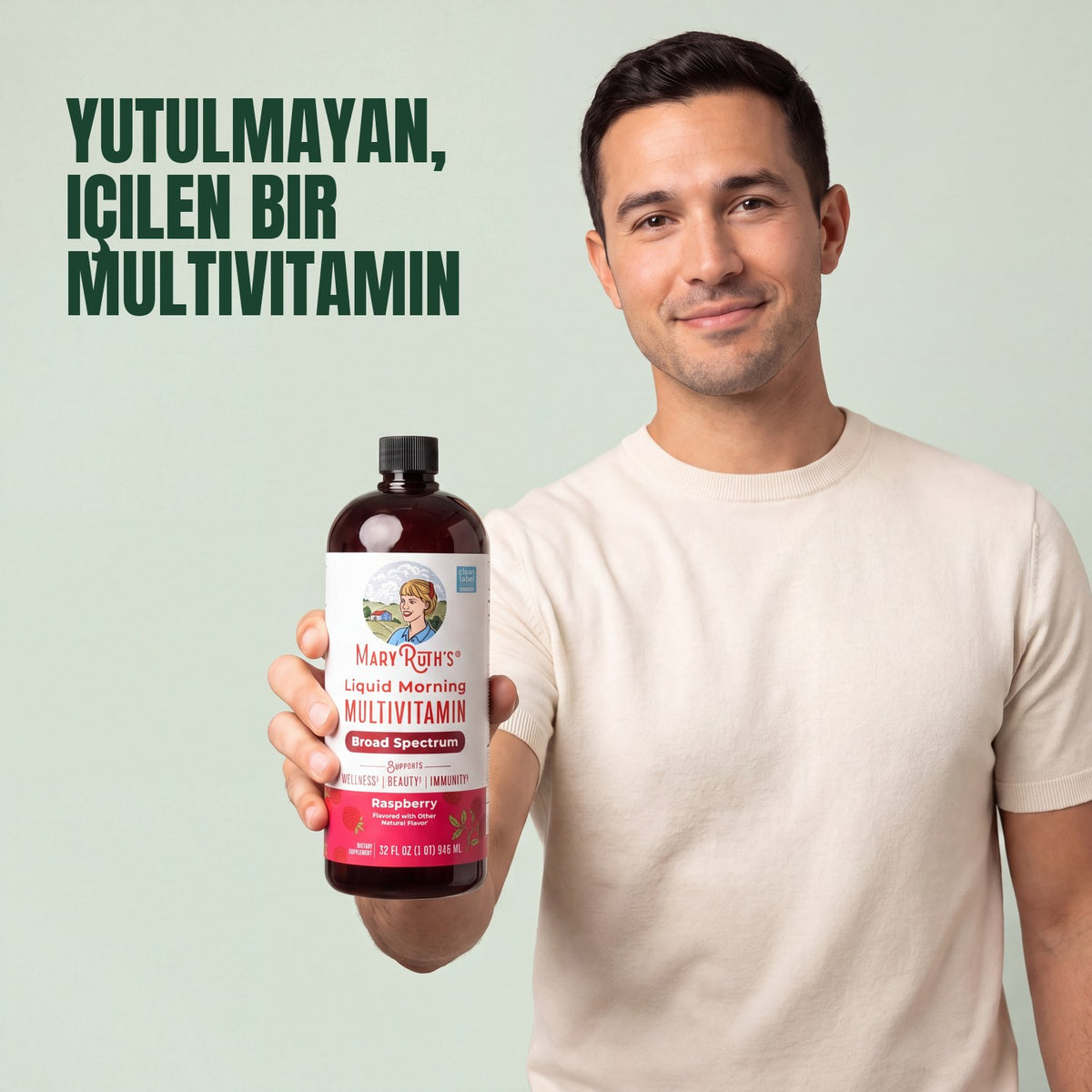 Man holding a MaryRuth Organics Liquid Morning Multivitamin raspberry bottle against a green background