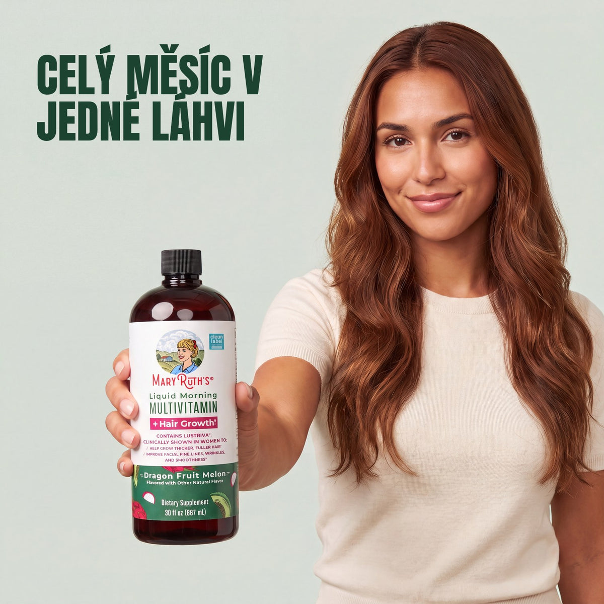 Woman holding a MaryRuth Organics Liquid Morning Multivitamin + Hair Growth dragon fruit melon bottle against a green background