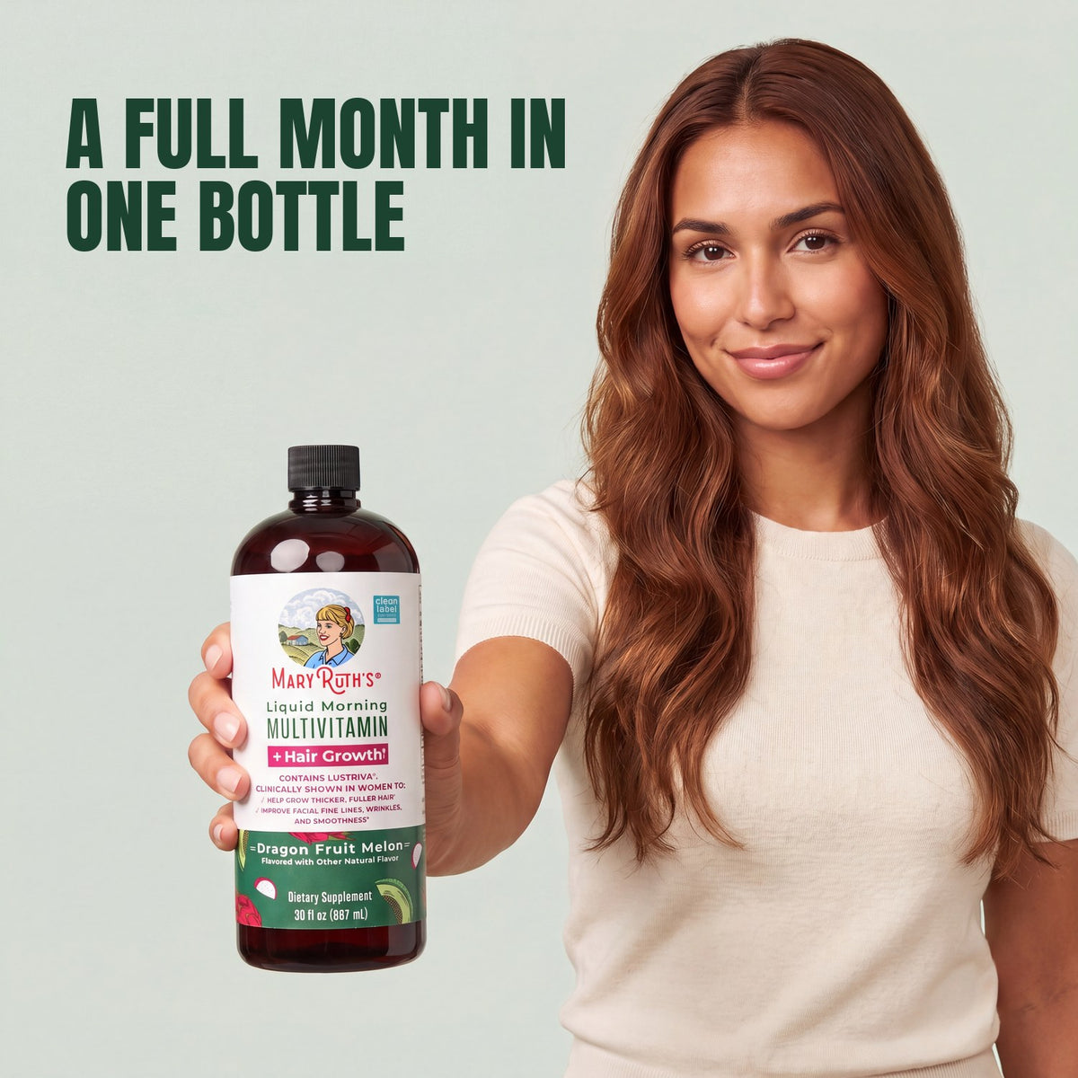 Woman holding a MaryRuth Organics Liquid Morning Multivitamin + Hair Growth dragon fruit melon bottle against a green background
