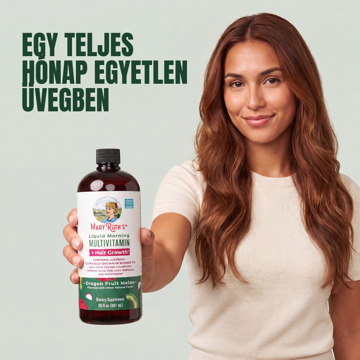 Woman holding a MaryRuth Organics Liquid Morning Multivitamin + Hair Growth dragon fruit melon bottle against a green background