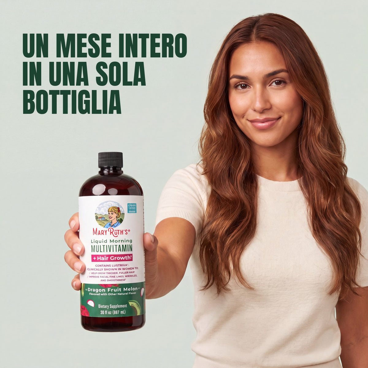 Woman holding a MaryRuth Organics Liquid Morning Multivitamin + Hair Growth dragon fruit melon bottle against a green background