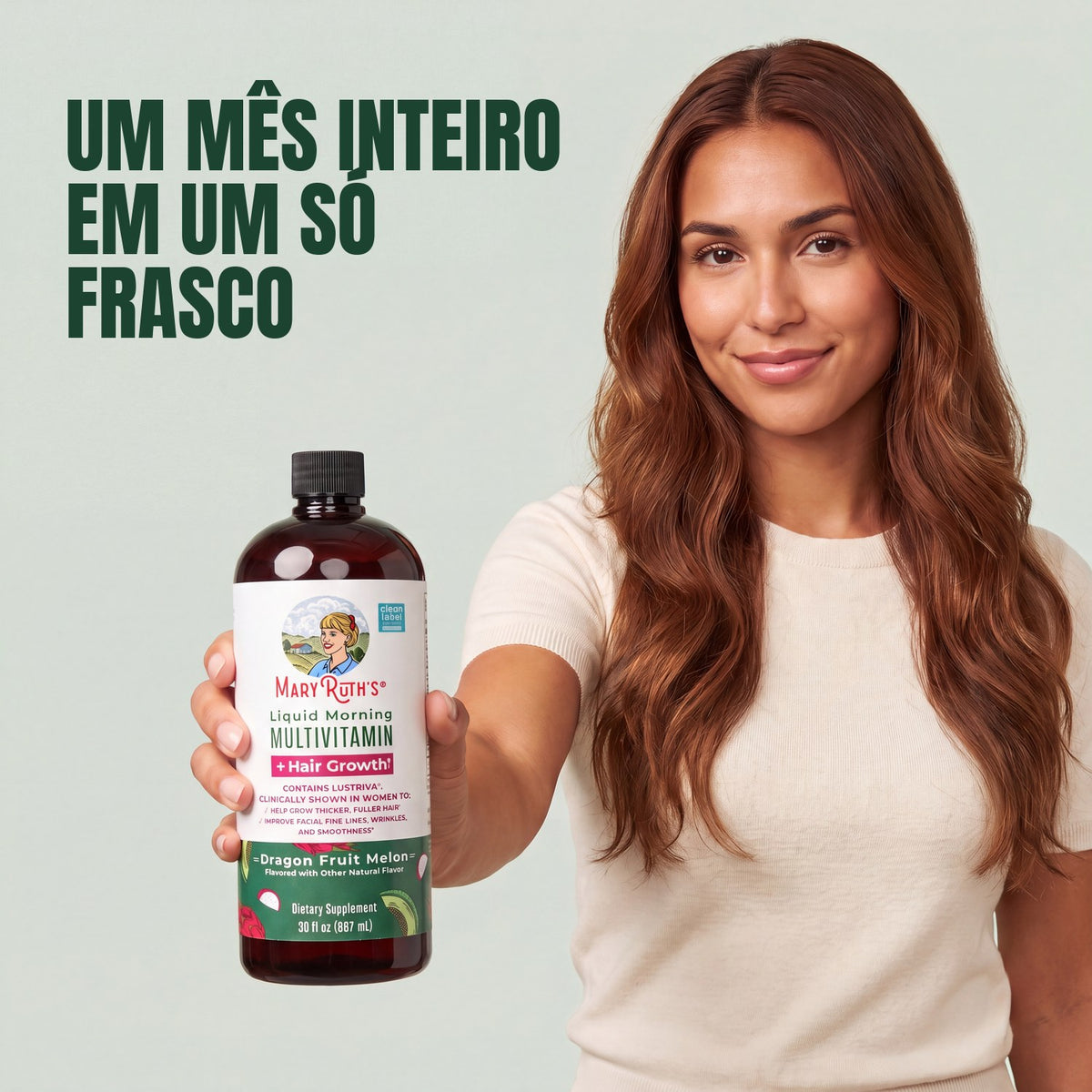 Woman holding a MaryRuth Organics Liquid Morning Multivitamin + Hair Growth dragon fruit melon bottle against a green background