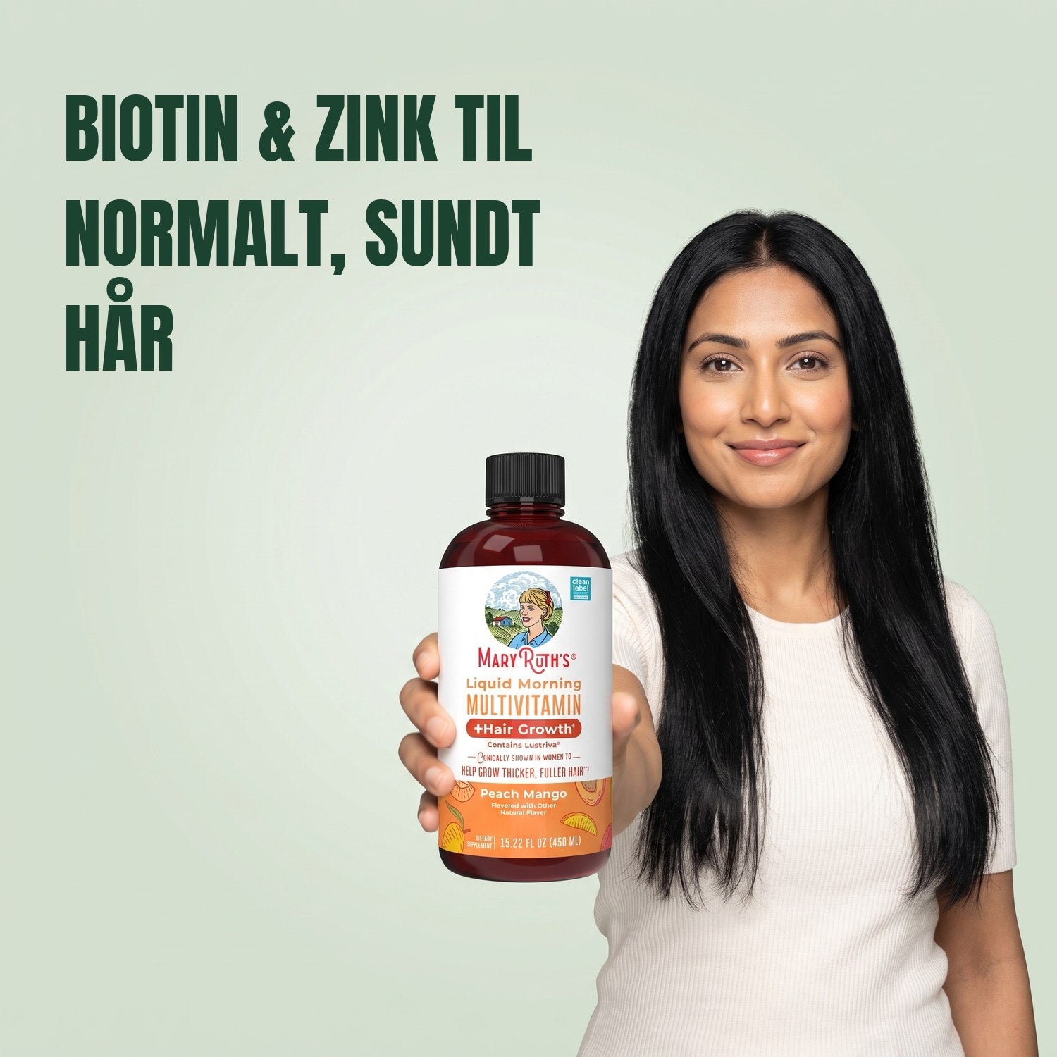 Kvinde holder en MaryRuth Organics Liquid Morning Multivitamin-flaske mod en grøn baggrund