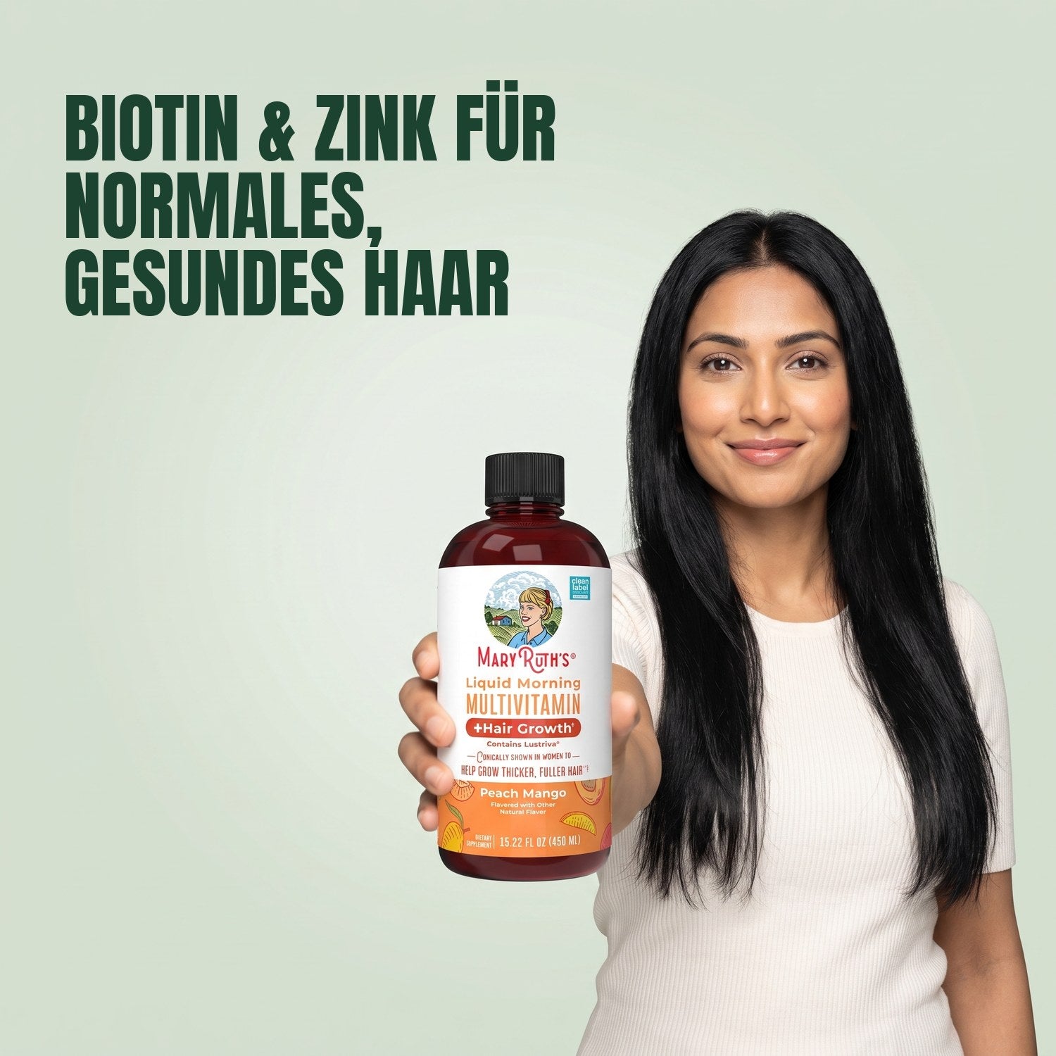 Woman holding a MaryRuth Organics Liquid Morning Multivitamin bottle against a green background