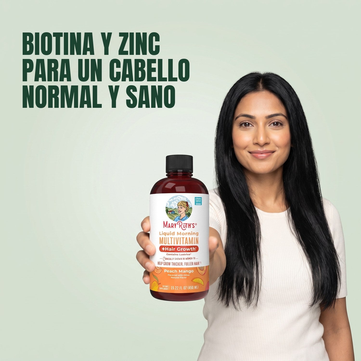 Woman holding a MaryRuth Organics Liquid Morning Multivitamin bottle against a green background