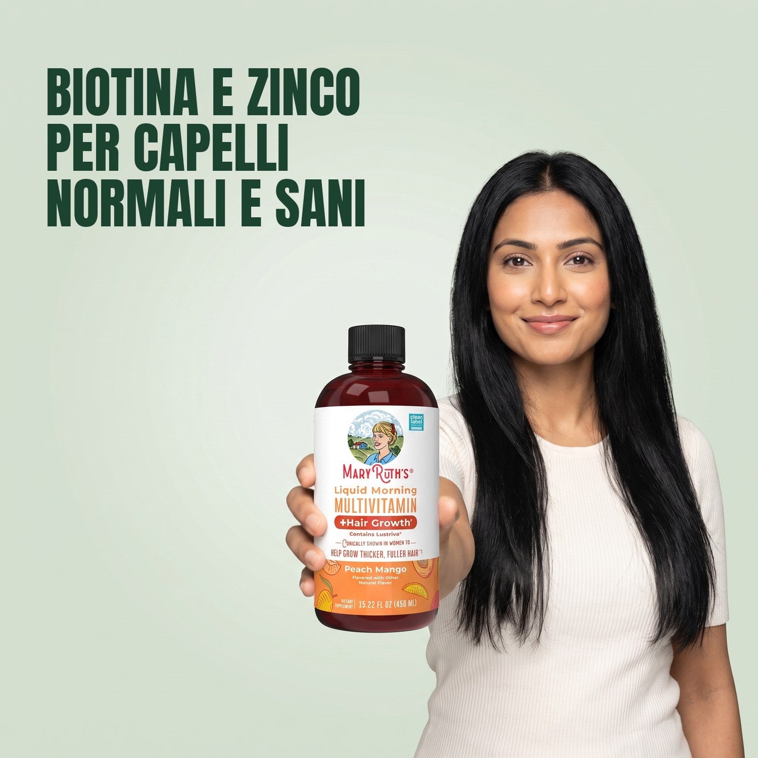 Woman holding a MaryRuth Organics Liquid Morning Multivitamin bottle against a green background