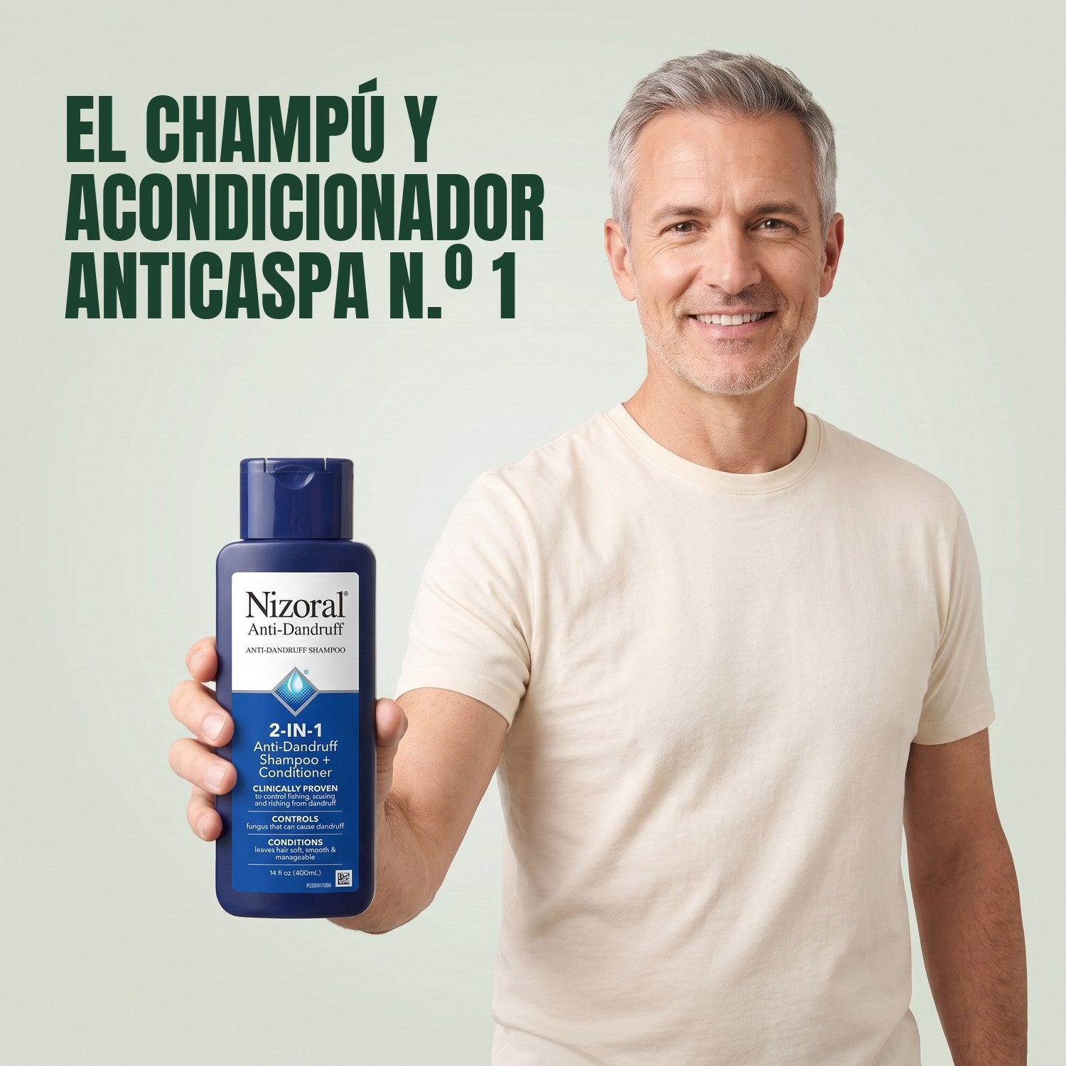 Man holding a Nizoral 2-in-1 anti-dandruff shampoo and conditioner bottle against a green background
