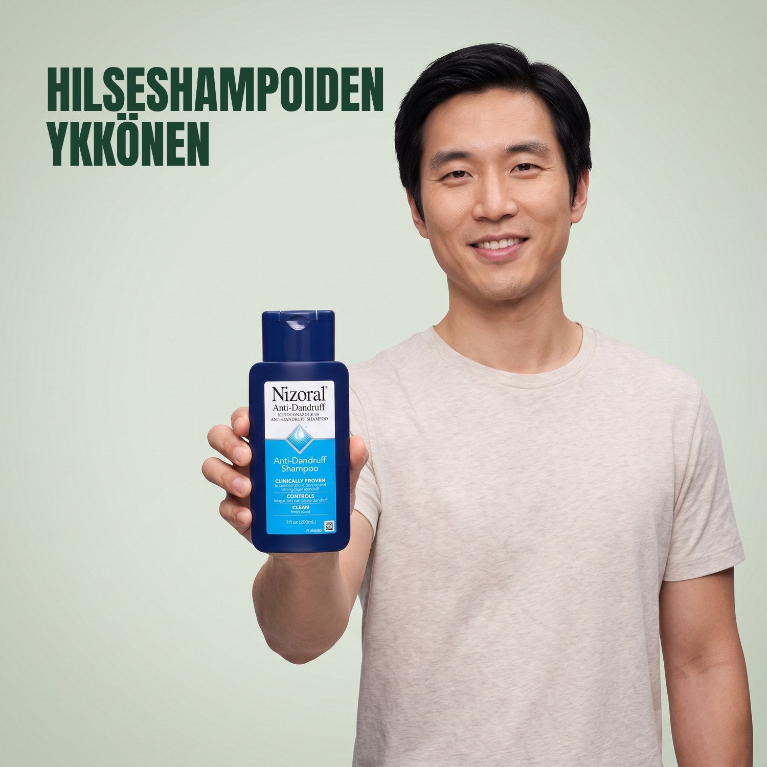Mies pitelee Nizoral-hilseshampoopulloa 1% vihreää taustaa vasten