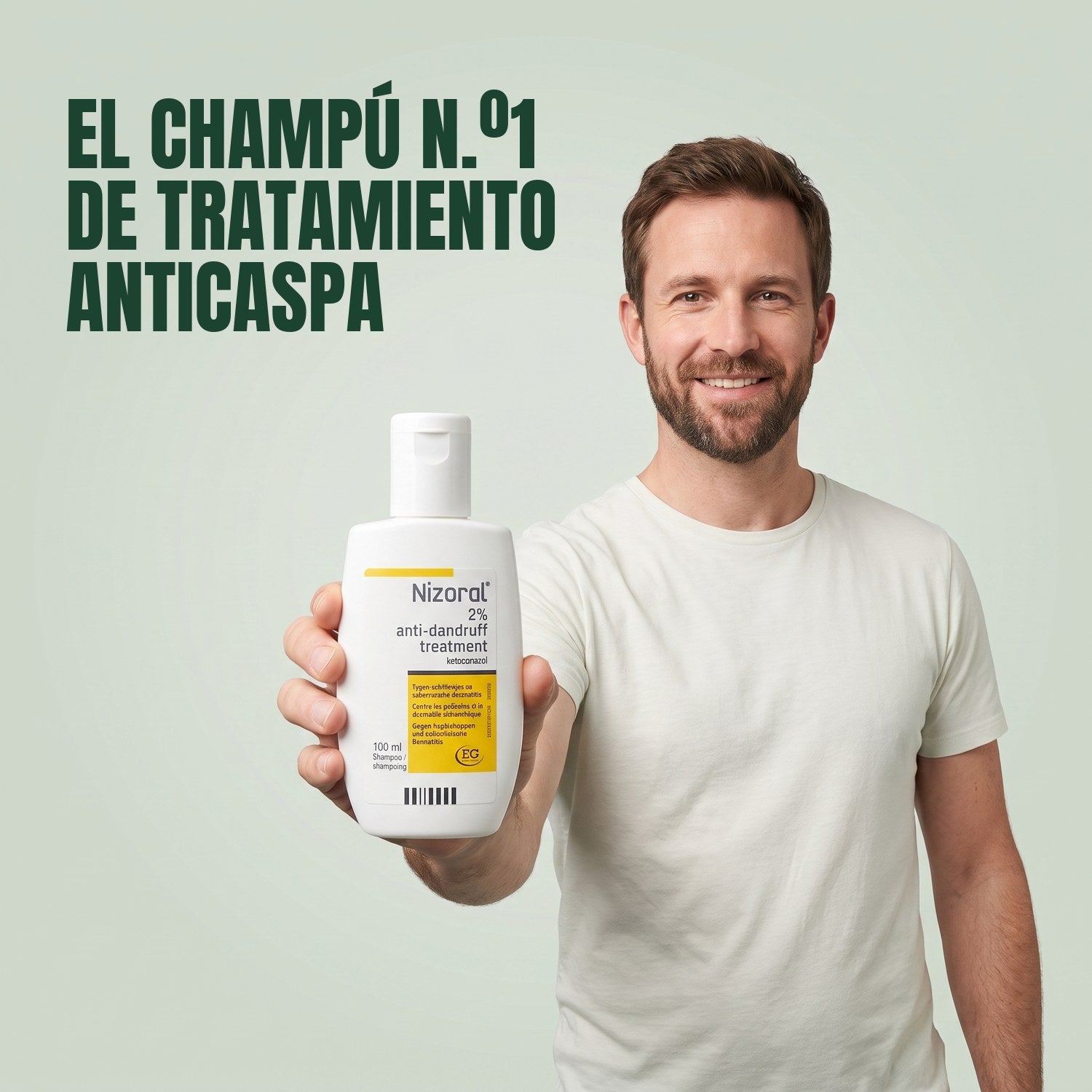 Man holding a Nizoral anti-dandruff treatment shampoo 2% 100 ml bottle against a green background