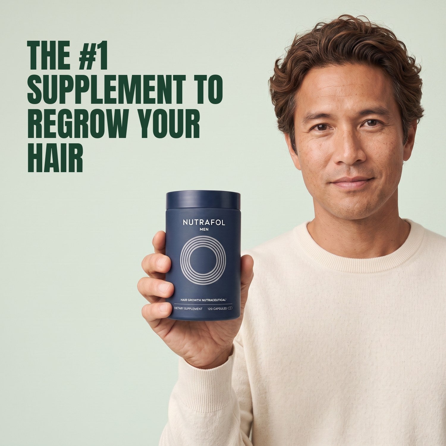 Man holding the Nutrafol for Men supplement box against a green background