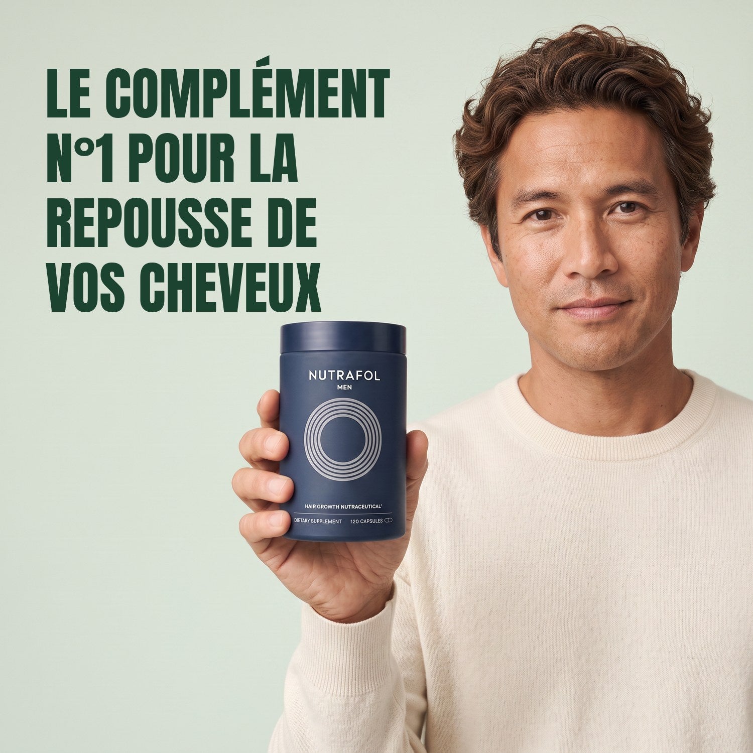 Man holding the Nutrafol for Men supplement box against a green background