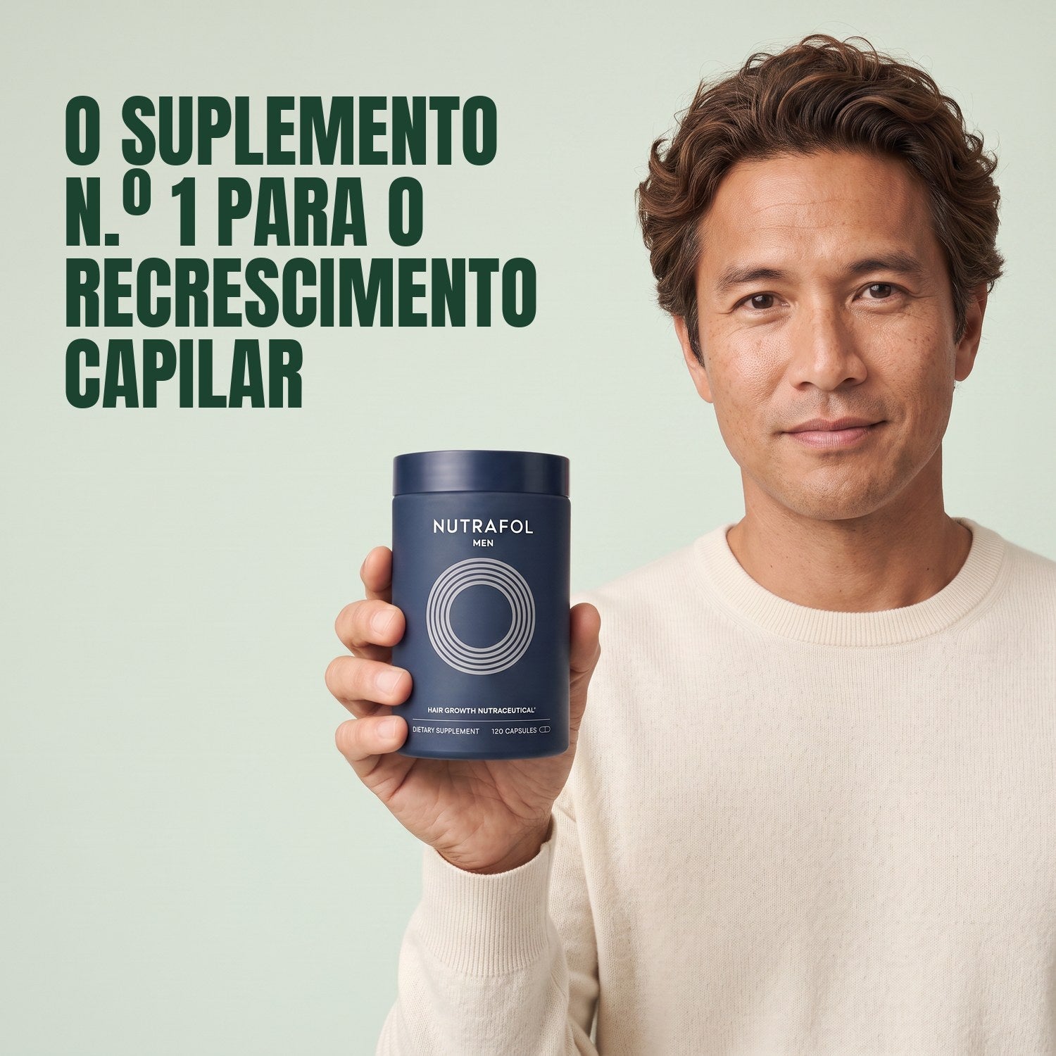 Man holding the Nutrafol for Men supplement box against a green background