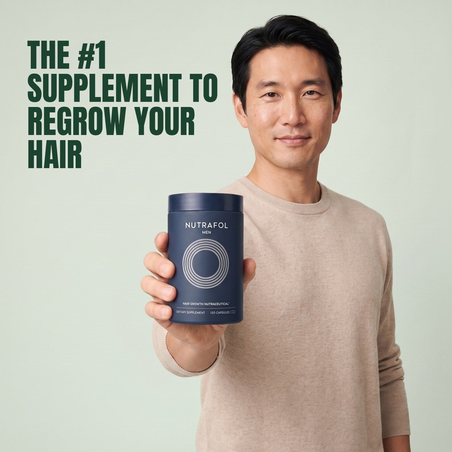 Man holding the Nutrafol for Men supplement box against a green background
