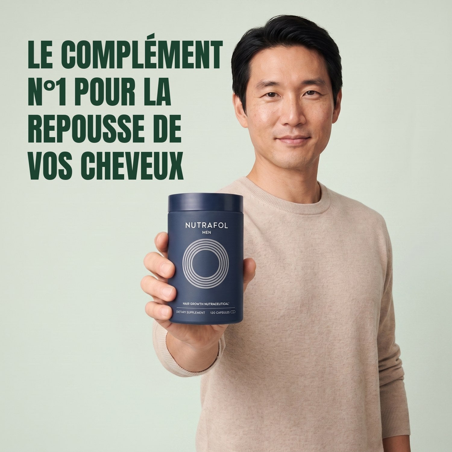 Man holding the Nutrafol for Men supplement box against a green background