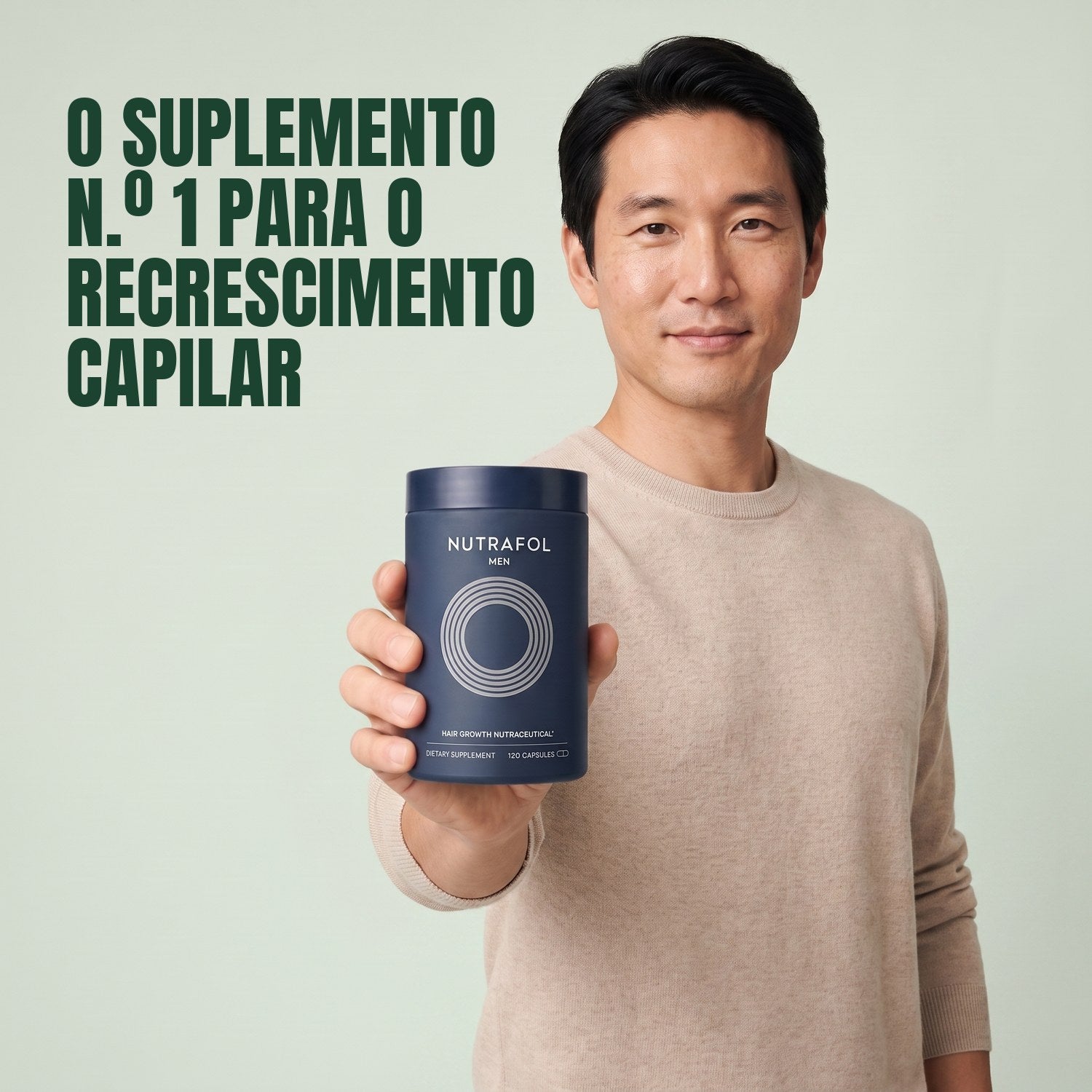 Man holding the Nutrafol for Men supplement box against a green background