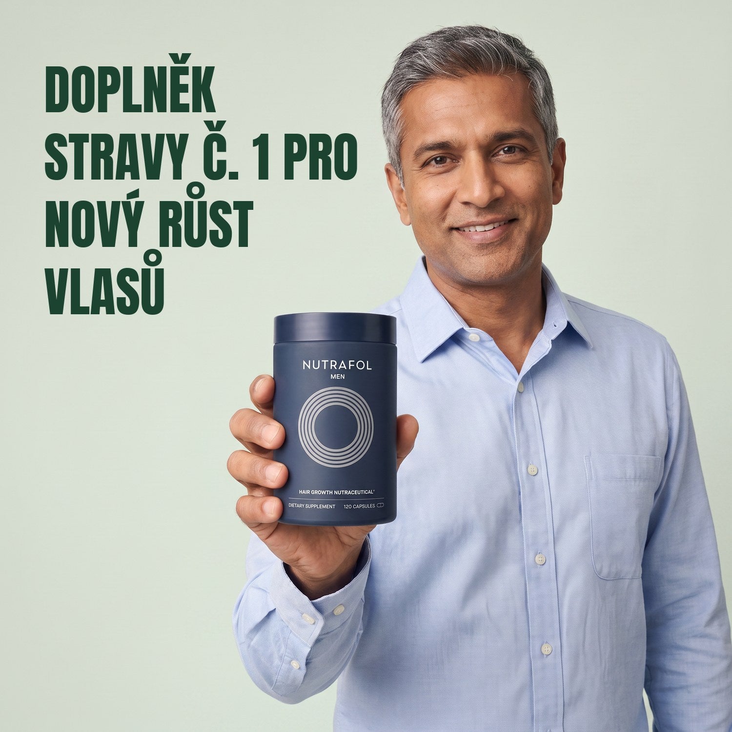 Muž drží krabičku doplňku stravy Nutrafol for Men na zeleném pozadí