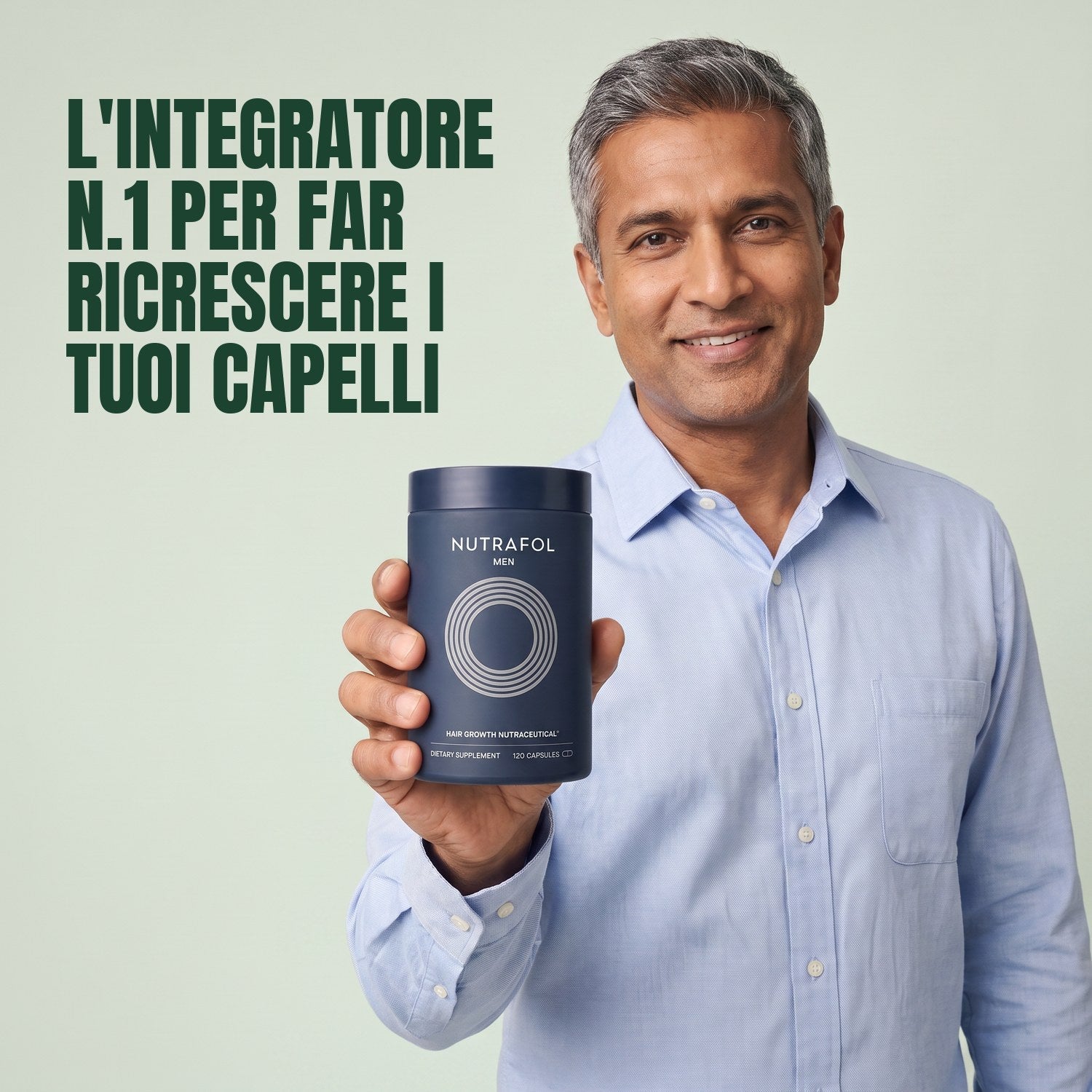 Man holding the Nutrafol for Men supplement box against a green background