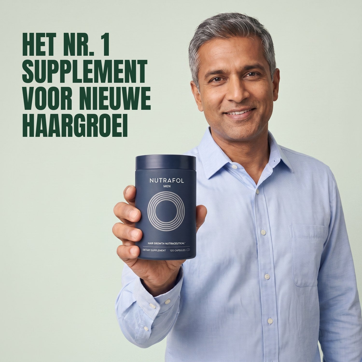 Man holding the Nutrafol for Men supplement box against a green background