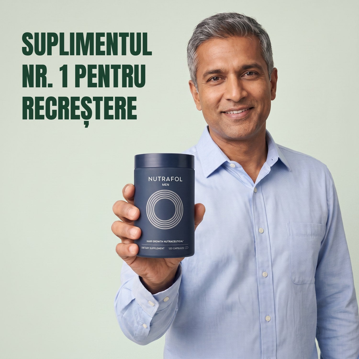 Bărbat ținând în mână cutia de suplimente Nutrafol for Men, pe fundal verde