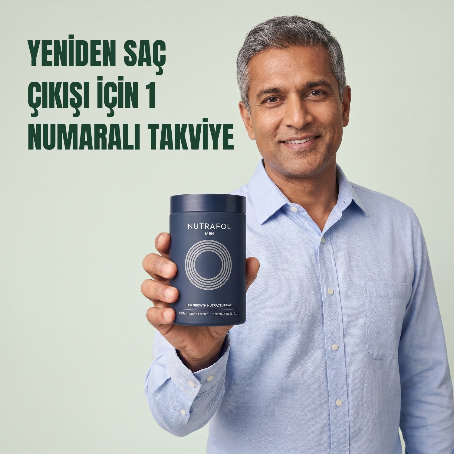 Man holding the Nutrafol for Men supplement box against a green background