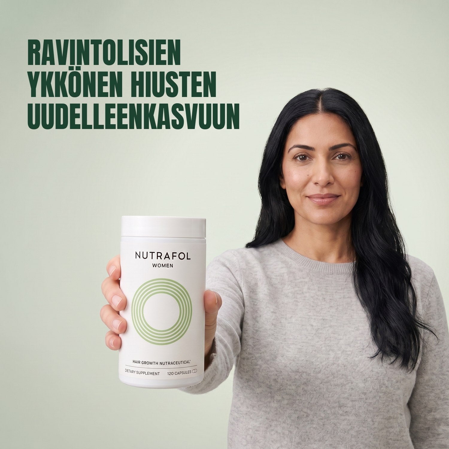 Woman holding the Nutrafol for Women 18-44 supplement box against a green background