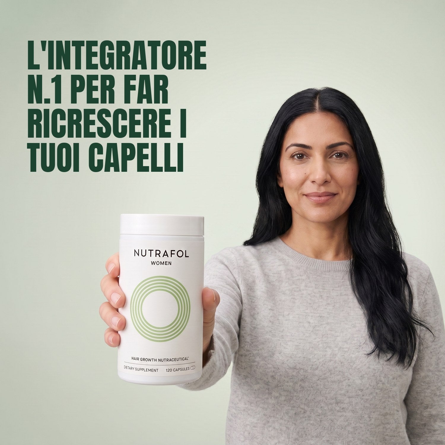 Woman holding the Nutrafol for Women 18-44 supplement box against a green background