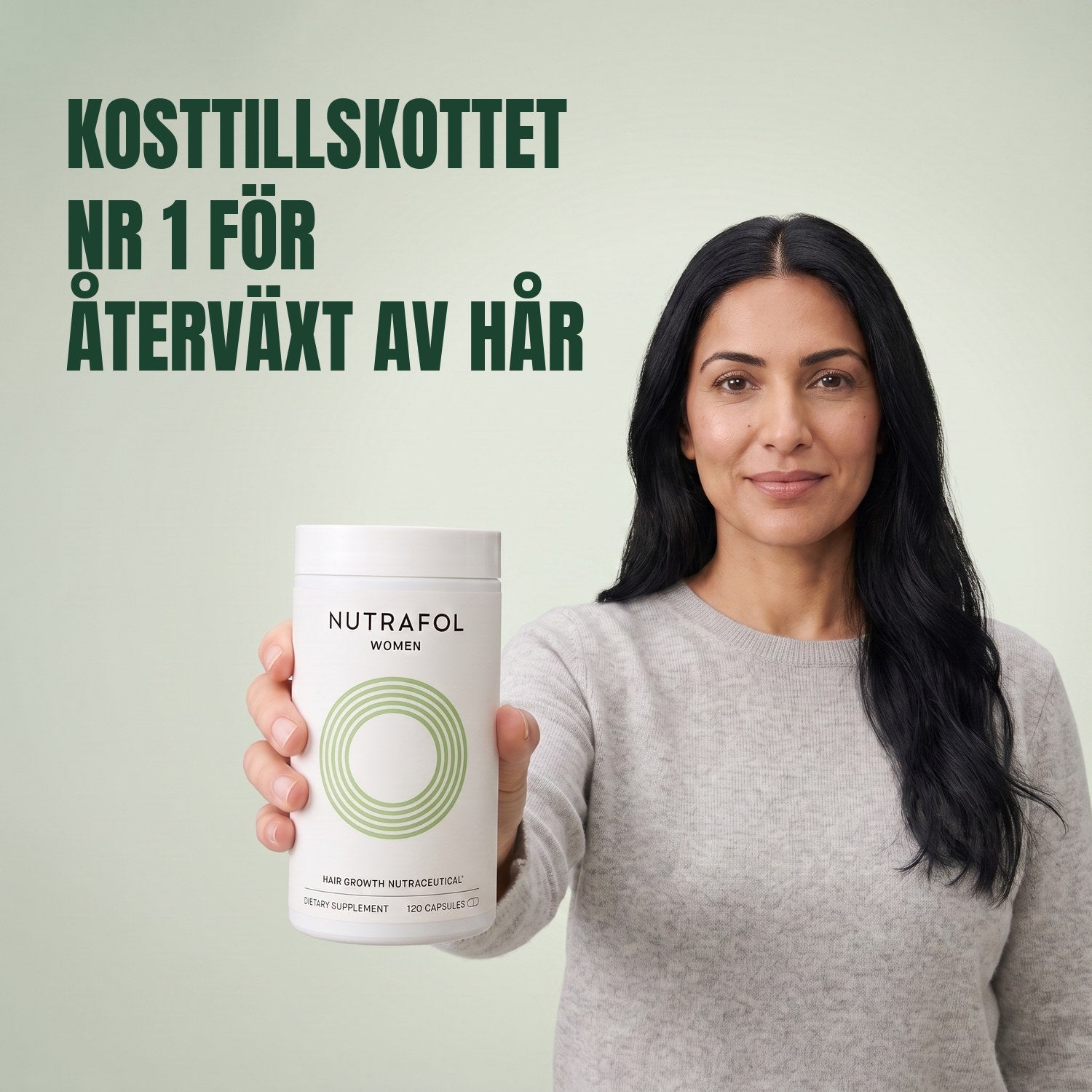 Woman holding the Nutrafol for Women 18-44 supplement box against a green background