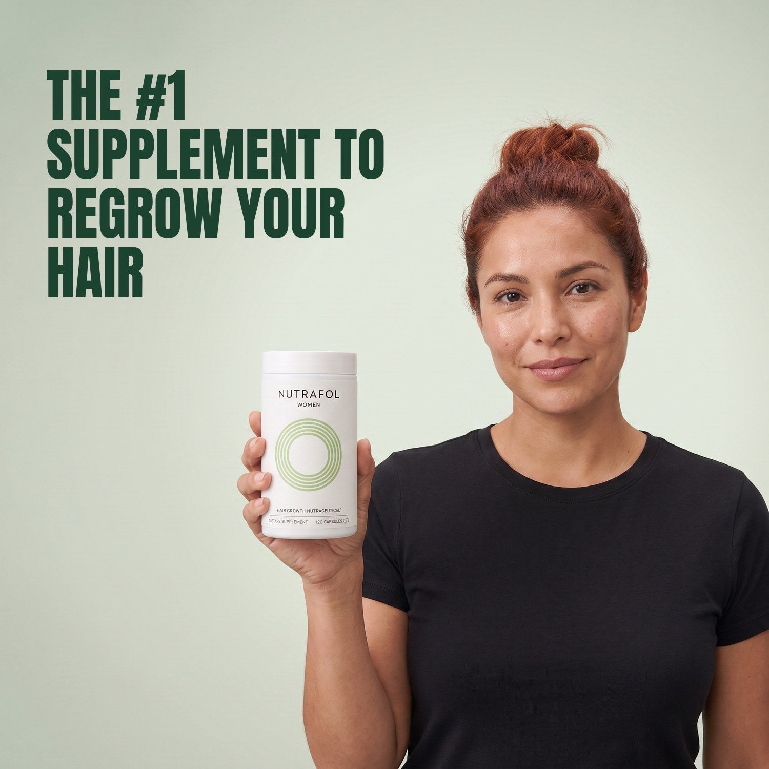 Woman holding the Nutrafol for Women 18-44 supplement box against a green background