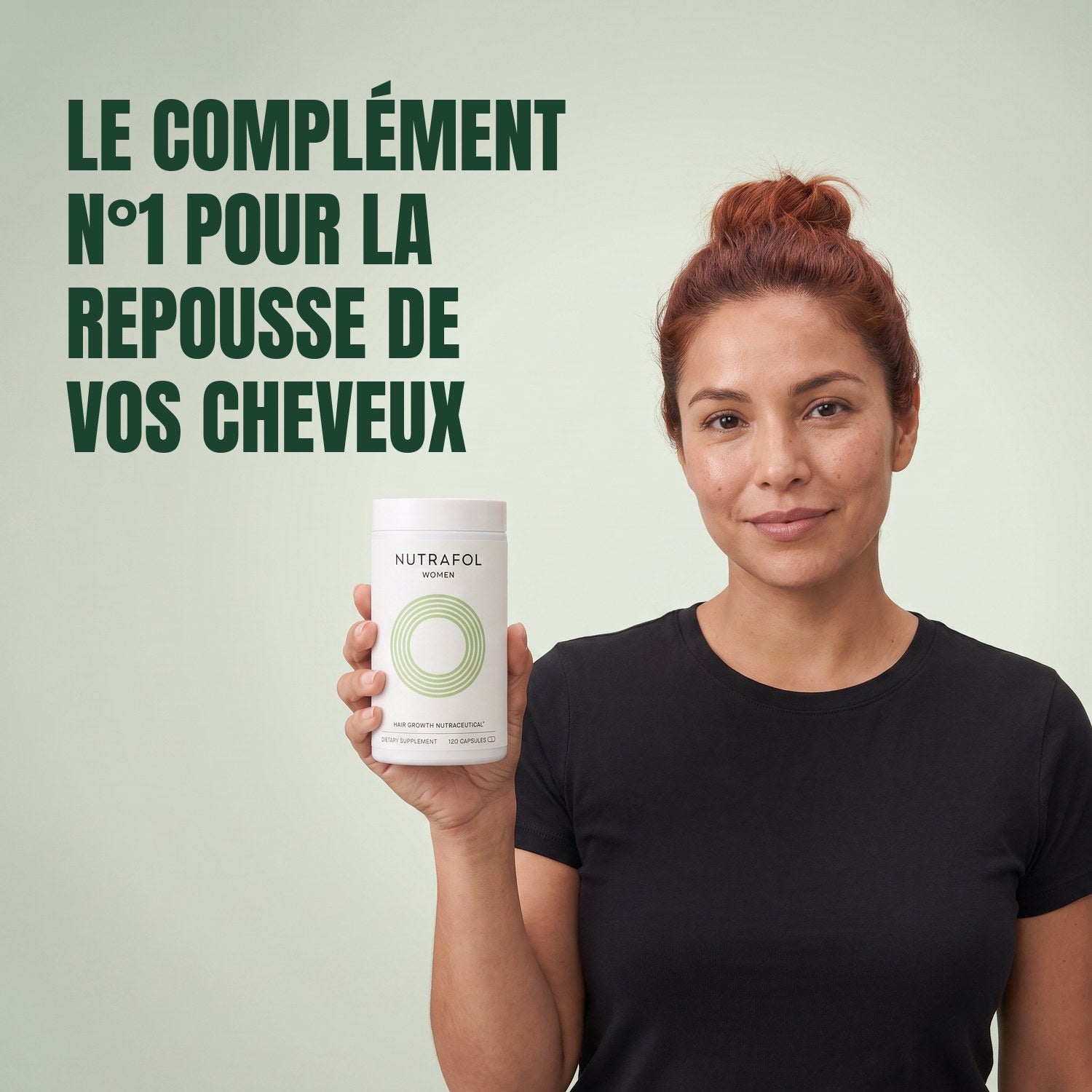 Woman holding the Nutrafol for Women 18-44 supplement box against a green background