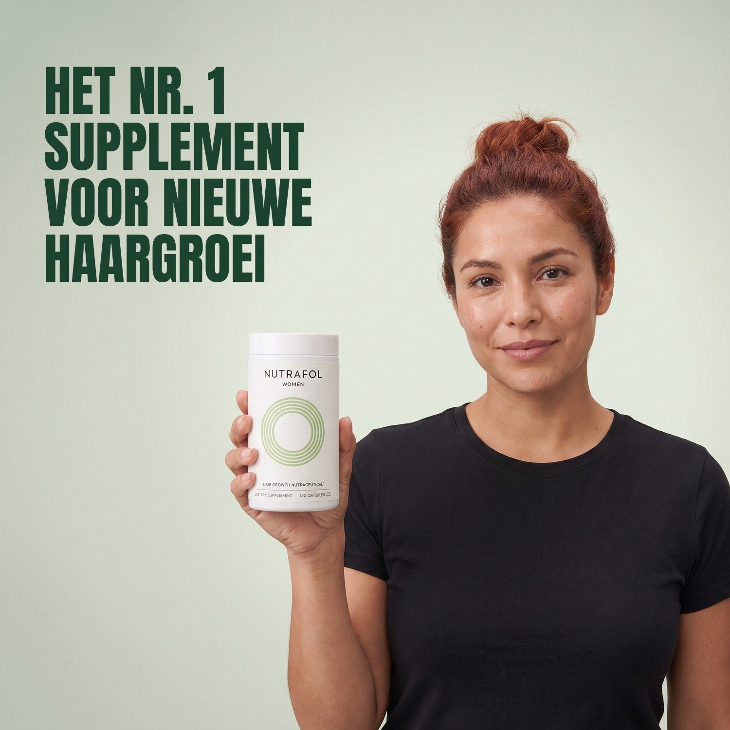Woman holding the Nutrafol for Women 18-44 supplement box against a green background