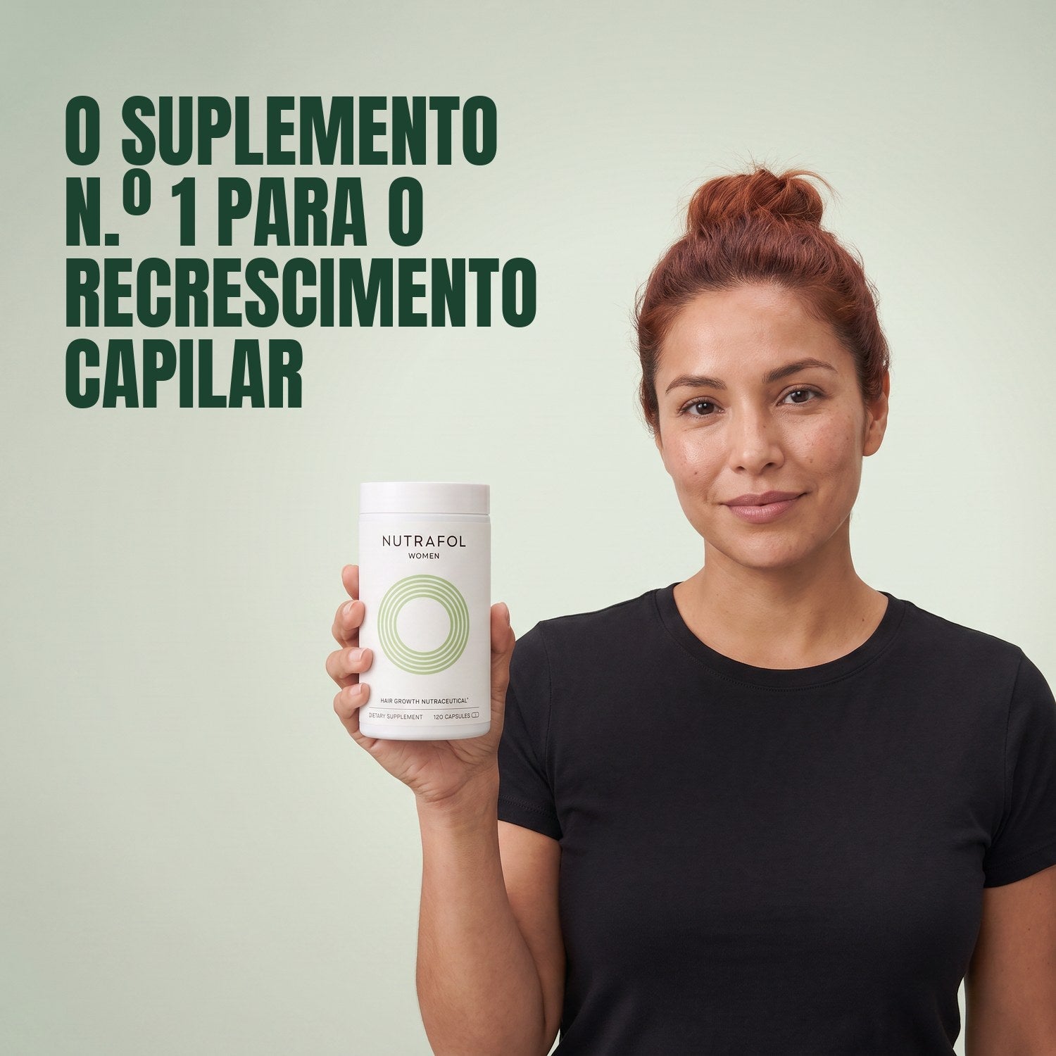 Woman holding the Nutrafol for Women 18-44 supplement box against a green background