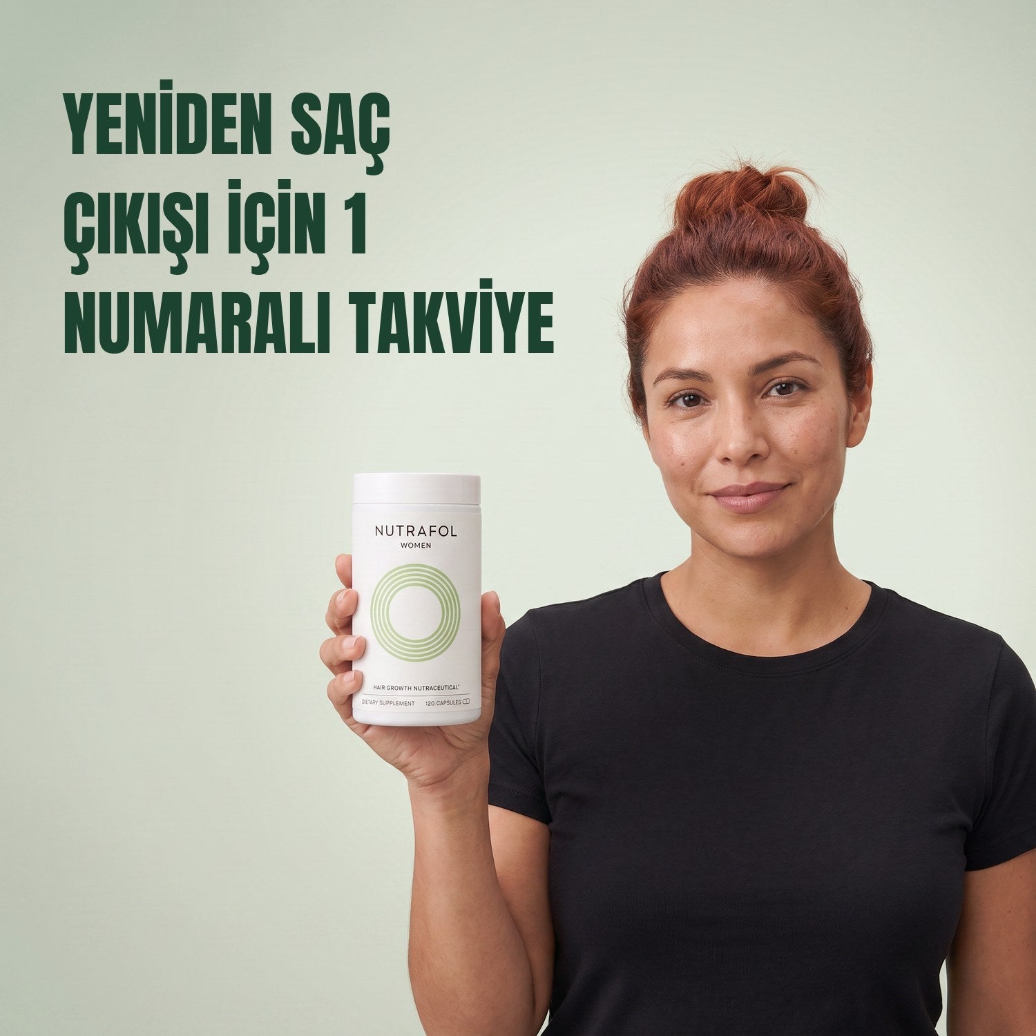 Woman holding the Nutrafol for Women 18-44 supplement box against a green background