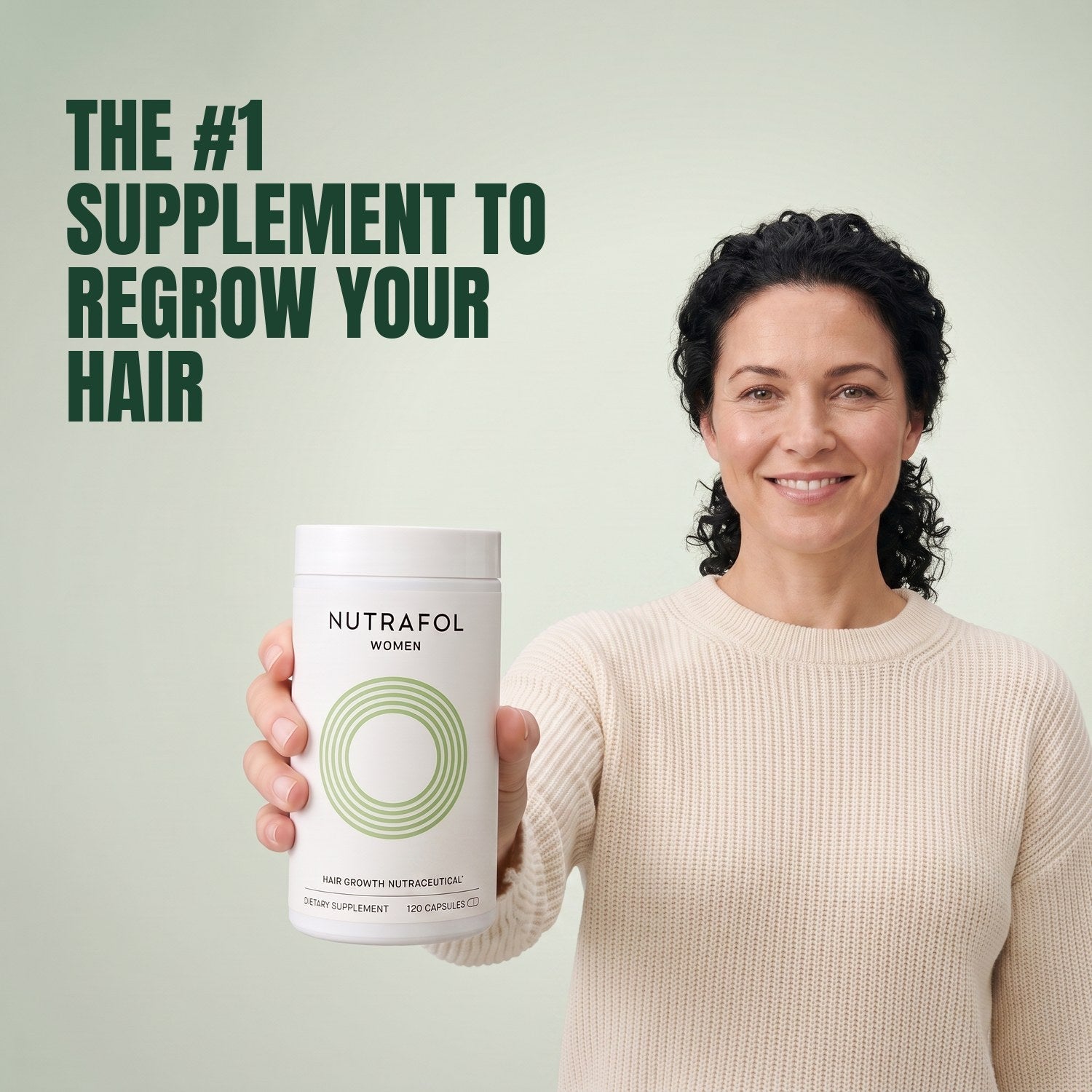 Woman holding the Nutrafol for Women 18-44 supplement box against a green background