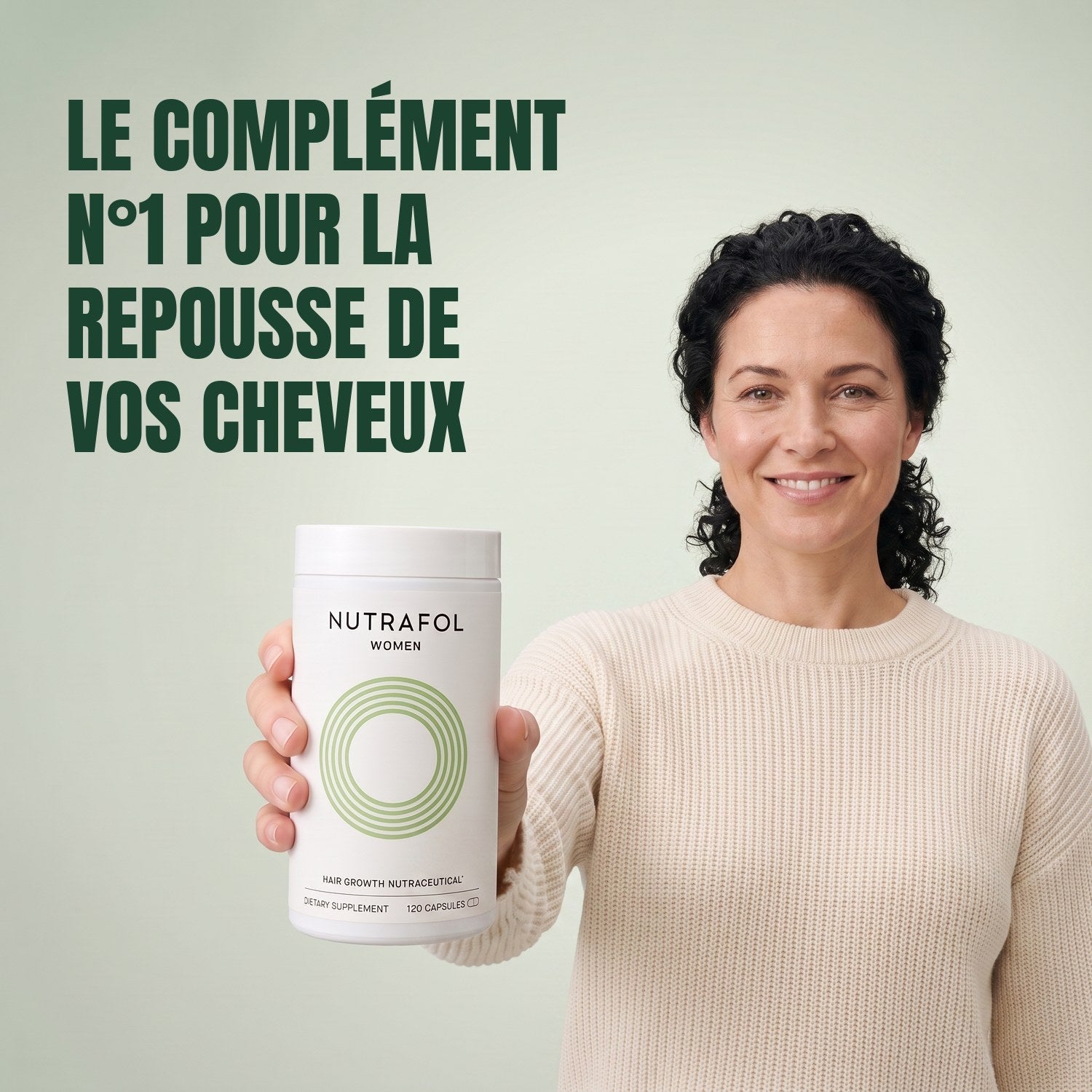 Woman holding the Nutrafol for Women 18-44 supplement box against a green background