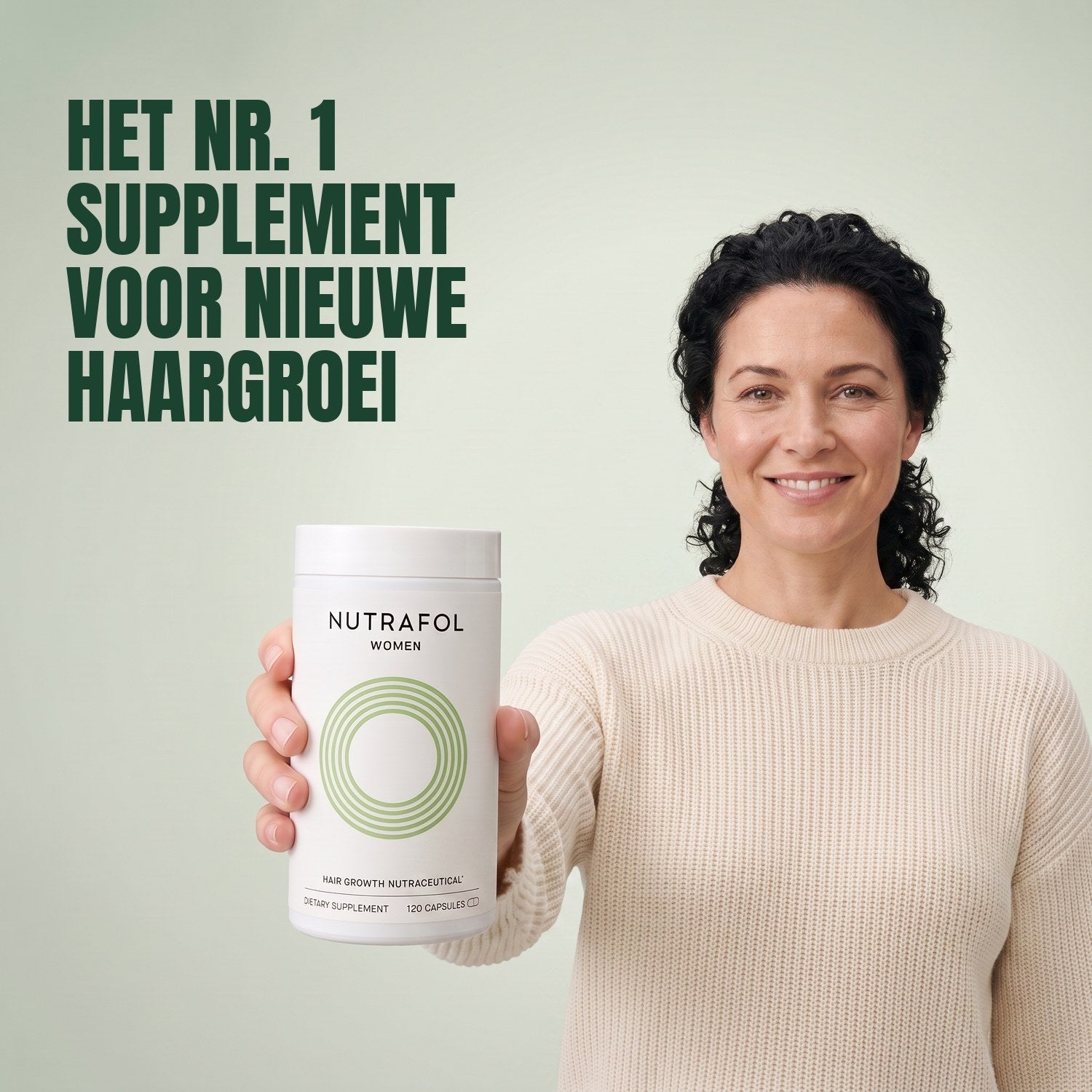 Woman holding the Nutrafol for Women 18-44 supplement box against a green background