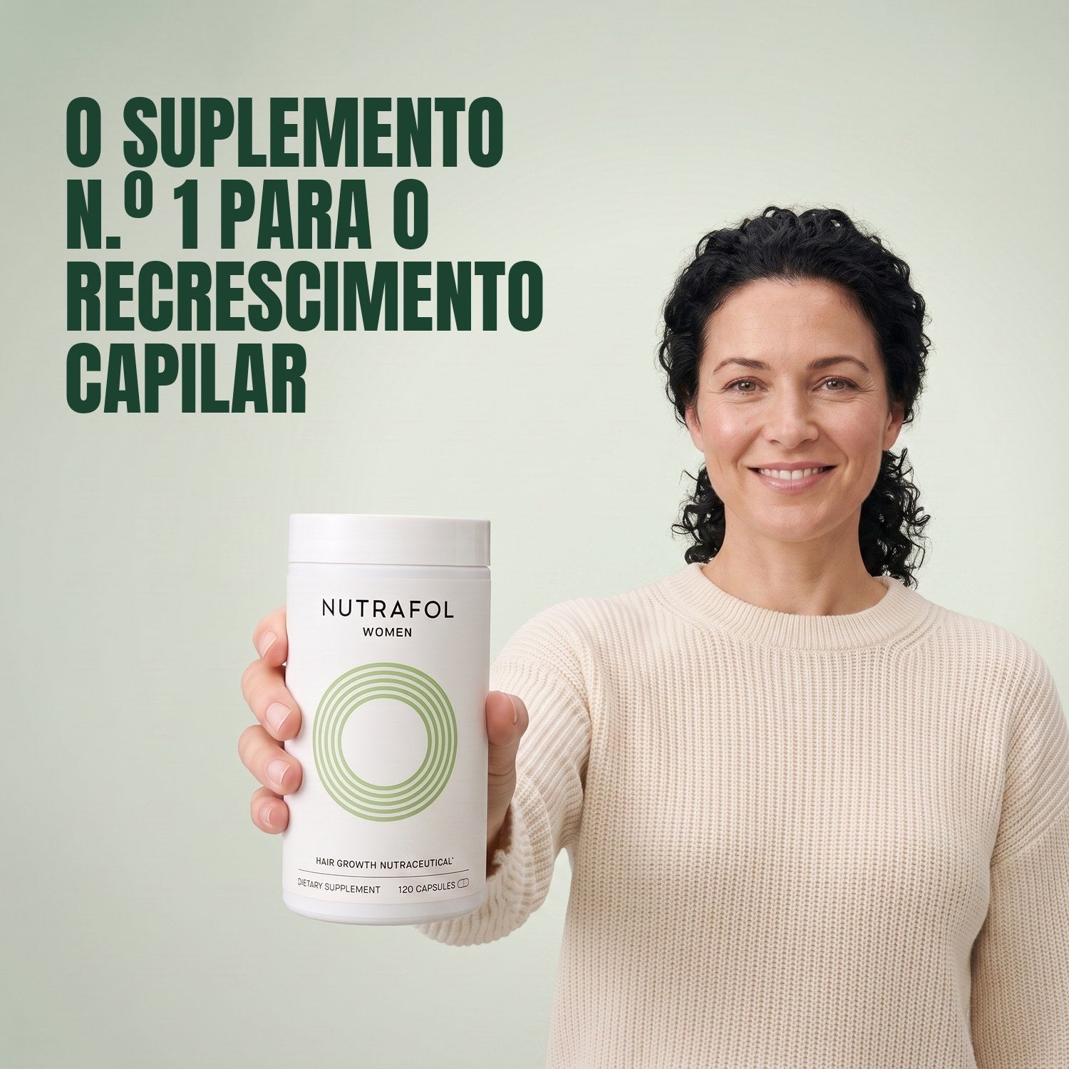 Woman holding the Nutrafol for Women 18-44 supplement box against a green background