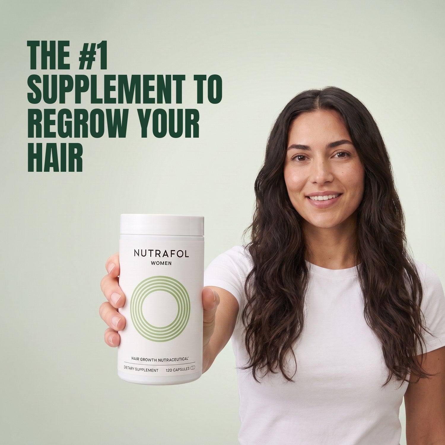 Woman holding the Nutrafol for Women 18-44 supplement box against a green background