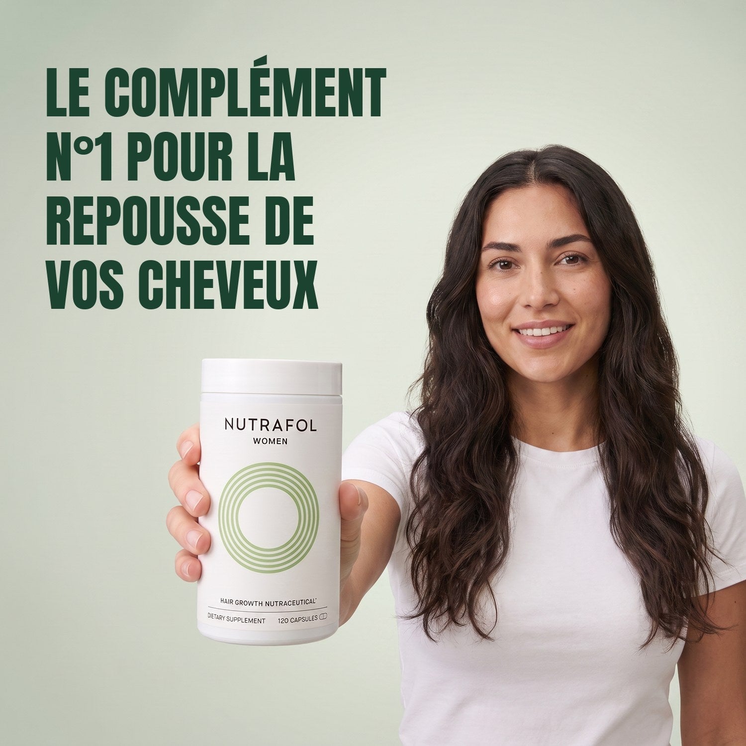 Woman holding the Nutrafol for Women 18-44 supplement box against a green background