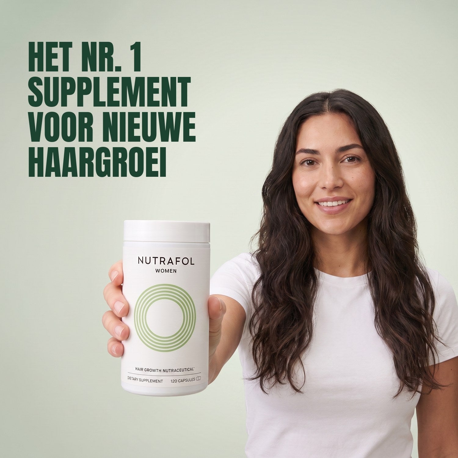 Woman holding the Nutrafol for Women 18-44 supplement box against a green background