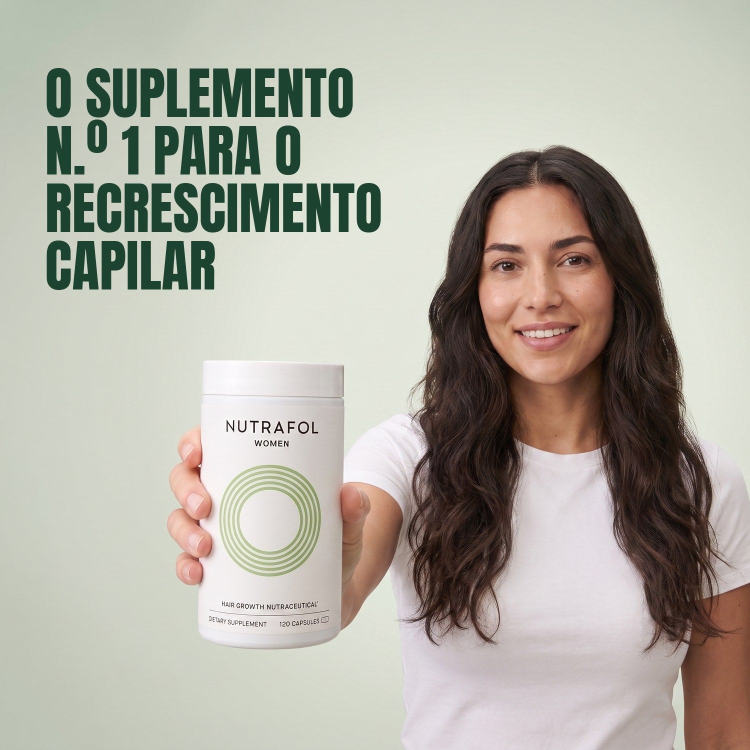 Woman holding the Nutrafol for Women 18-44 supplement box against a green background