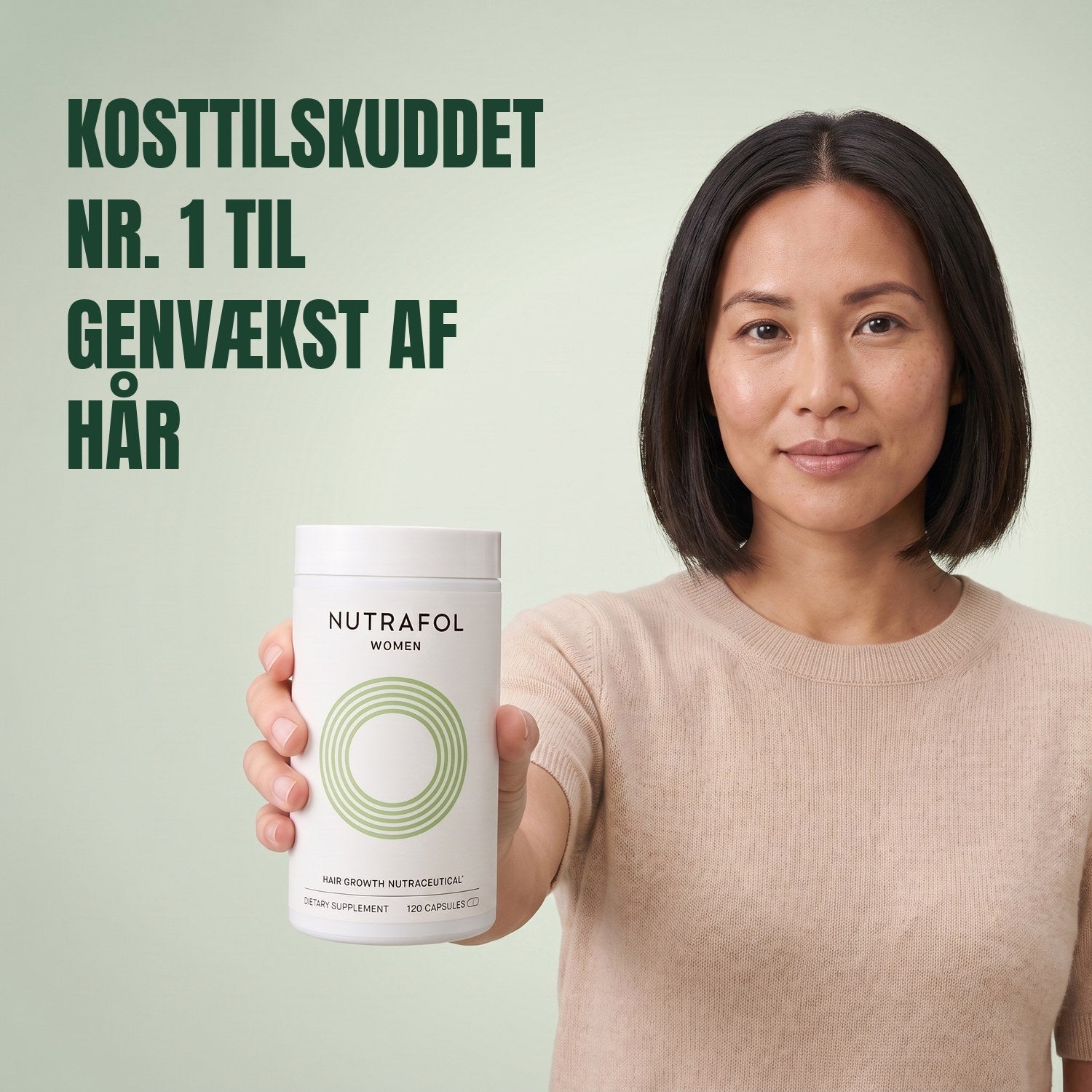 Woman holding the Nutrafol for Women 18-44 supplement box against a green background
