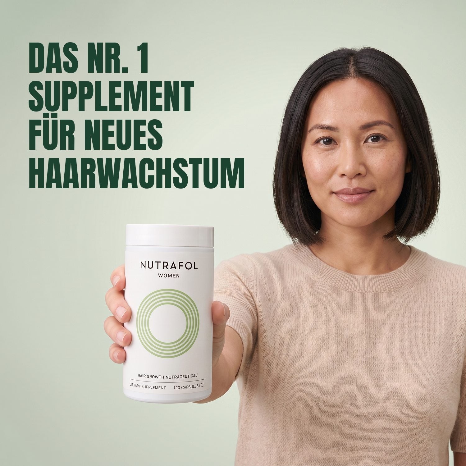 Woman holding the Nutrafol for Women 18-44 supplement box against a green background