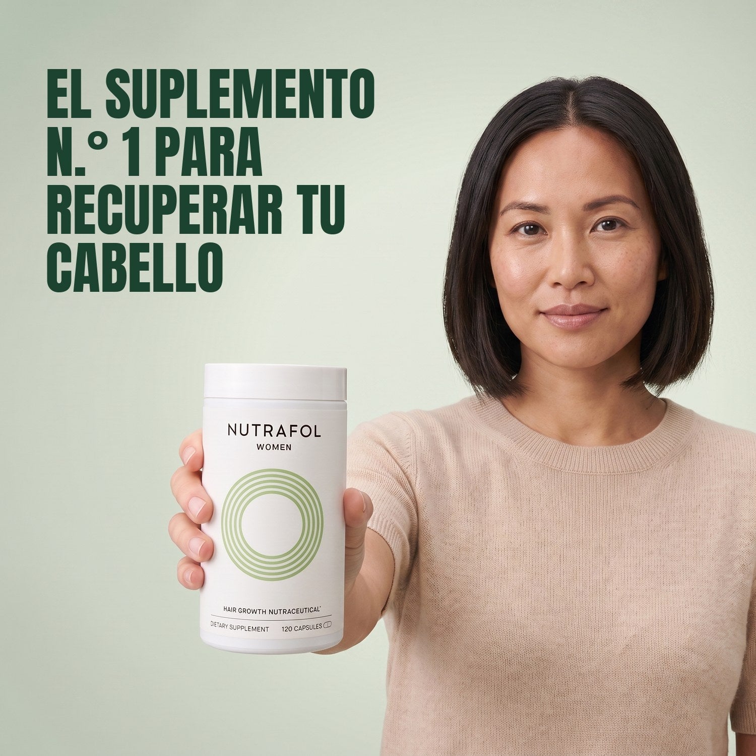 Woman holding the Nutrafol for Women 18-44 supplement box against a green background