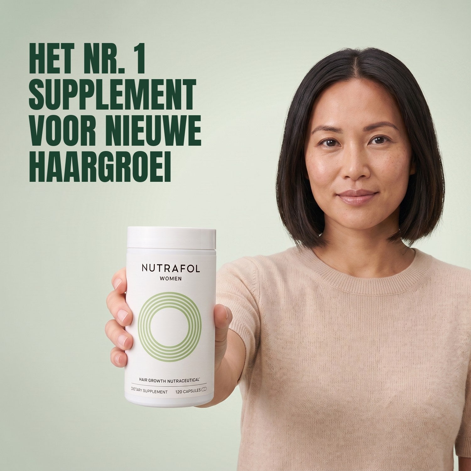 Woman holding the Nutrafol for Women 18-44 supplement box against a green background